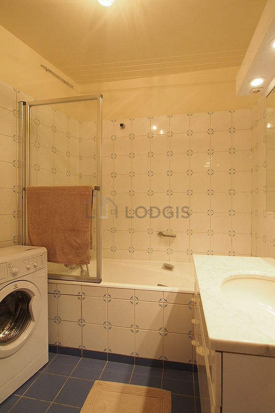 Bathroom equipped with washing machine, bath towels