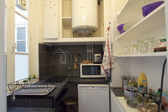 Kitchen equipped with hob, refrigerator, crockery