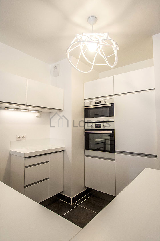 Kitchen equipped with dishwasher, hob, refrigerator, crockery