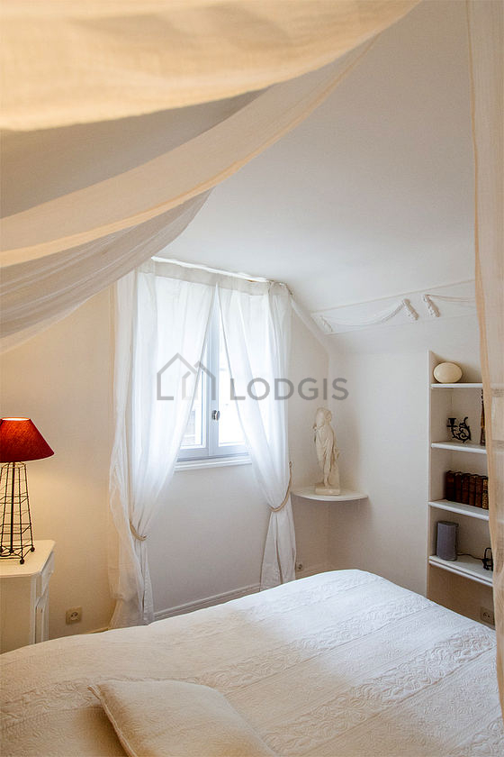 Bright bedroom equipped with bedside table