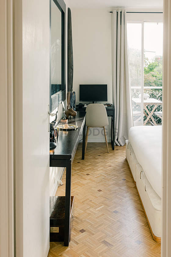 Bright bedroom equipped with 1 armchair(s), bedside table