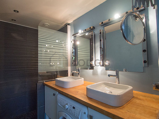 Bathroom equipped with washing machine, dryer, bath towels