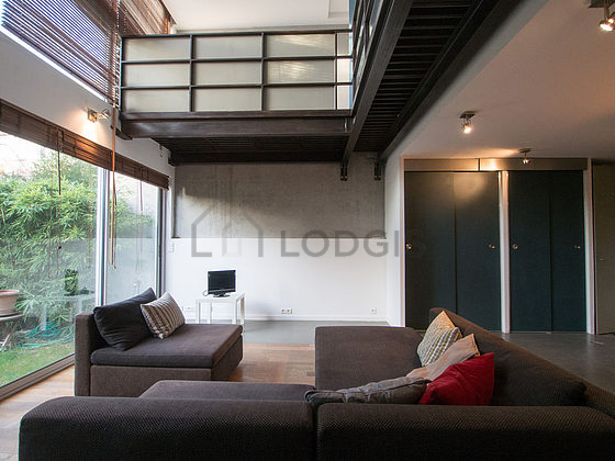 Living room with double-glazed windows facing the garden
