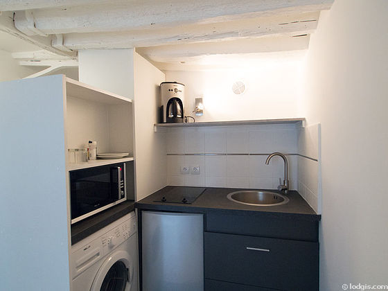 Kitchen equipped with washing machine, refrigerator, crockery