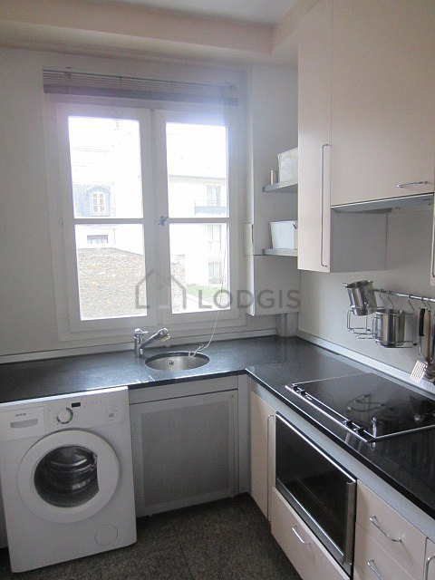 Kitchen equipped with washing machine, refrigerator, freezer, extractor hood