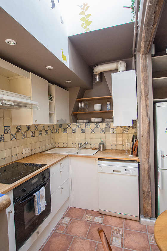 Kitchen where you can have dinner for 2 person(s) equipped with washing machine, refrigerator, extractor hood, crockery