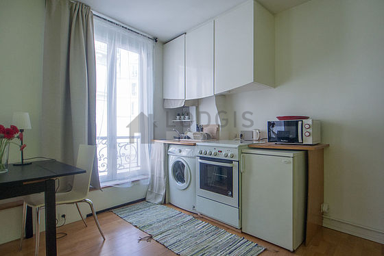 Kitchen equipped with washing machine, refrigerator, freezer, crockery
