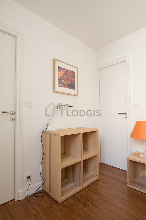 Bright bedroom equipped with bedside table