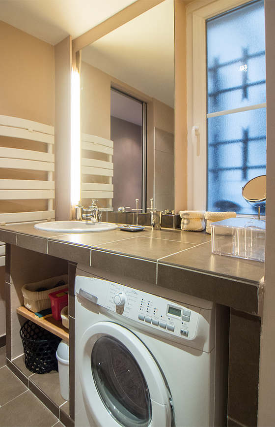 Bathroom equipped with washing machine, dryer, bath towels