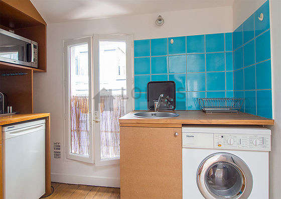 Bright kitchen with double-glazed windows facing the courtyard