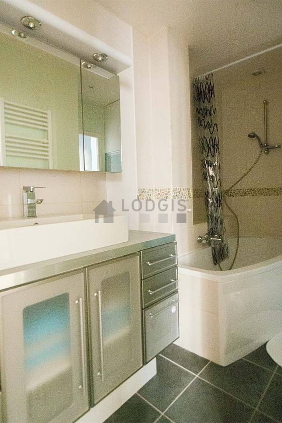 Bathroom equipped with washing machine, dryer, bath towels