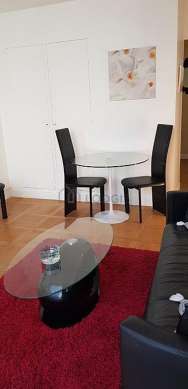 Very quiet living room furnished with tv, hi-fi stereo, 1 armchair(s), 3 chair(s)
