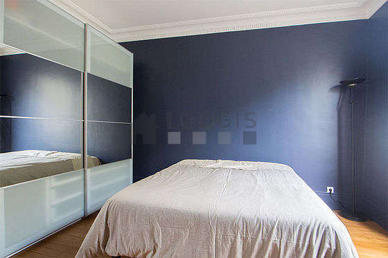 Bright bedroom equipped with wardrobe