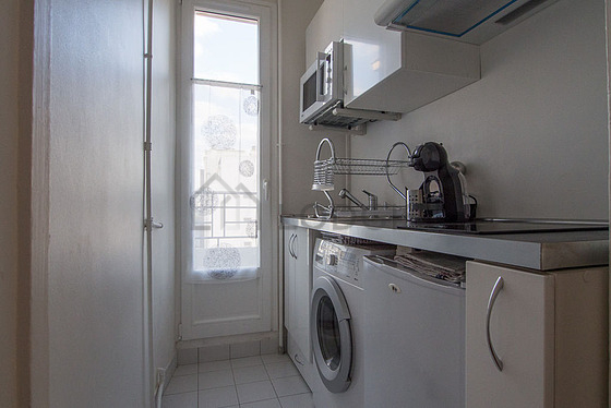 Kitchen equipped with washing machine, refrigerator, freezer, crockery
