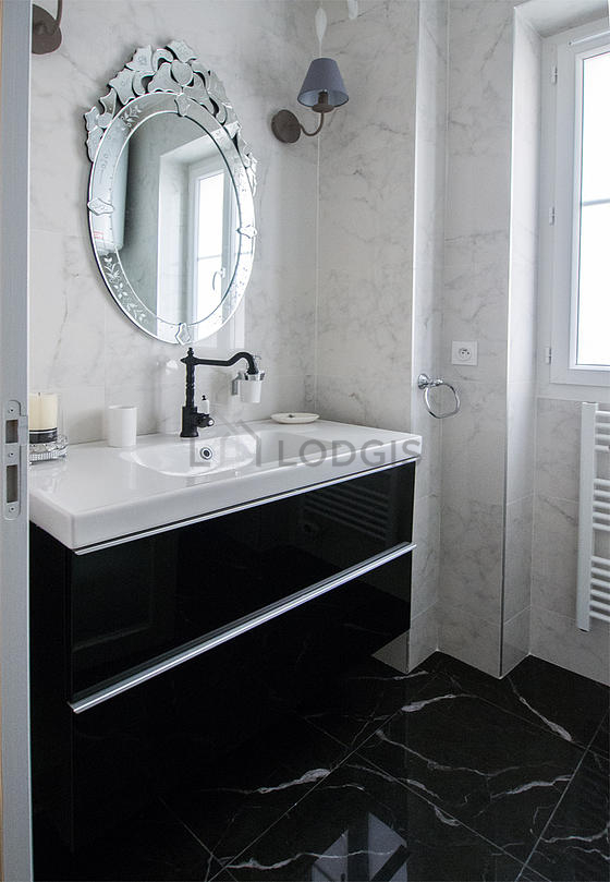 Pleasant and bright bathroom with windows and with tile floor