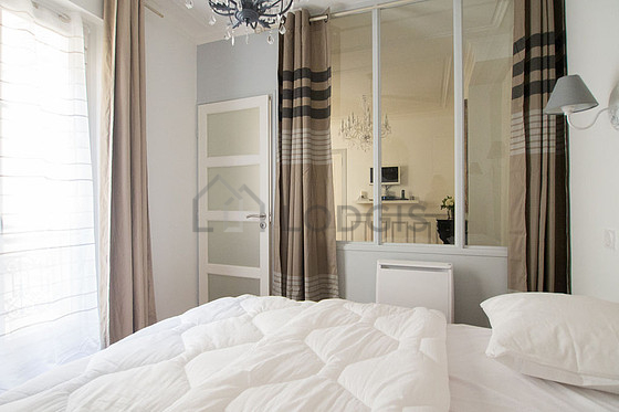 Bright bedroom equipped with wardrobe, cupboard, bedside table