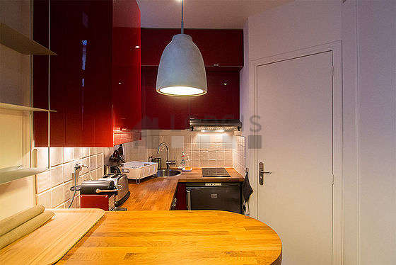 Kitchen equipped with crockery, stool