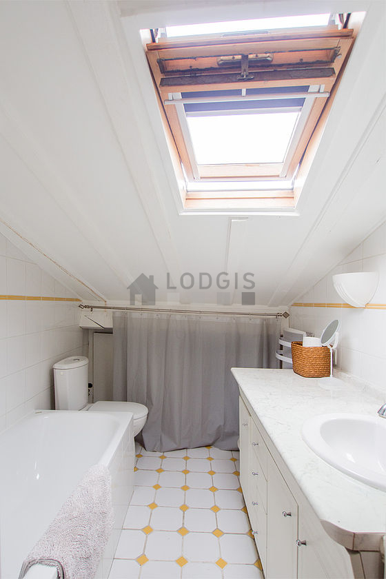 Bright bathroom with double-glazed windows and with tile floor