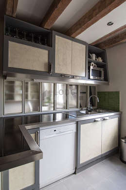 Kitchen equipped with dishwasher, hob, refrigerator, extractor hood