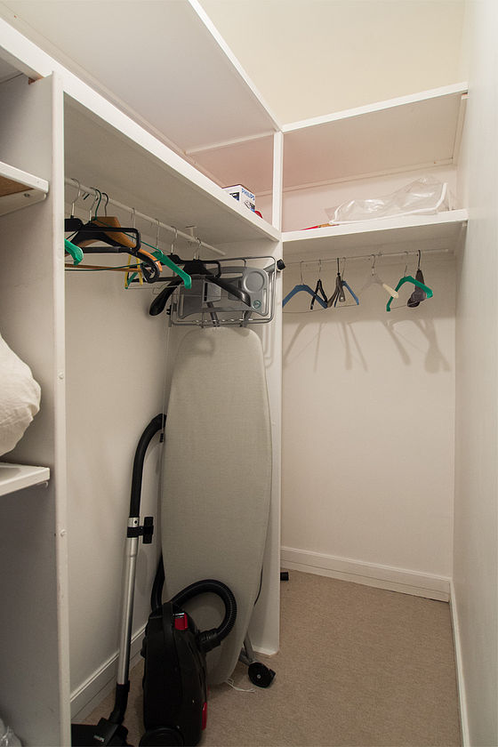 Quiet walk-in closet with the carpeting floor