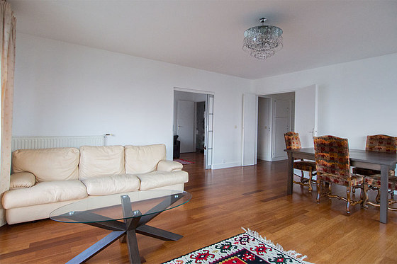 Living room with windows and balcony facing the courtyard