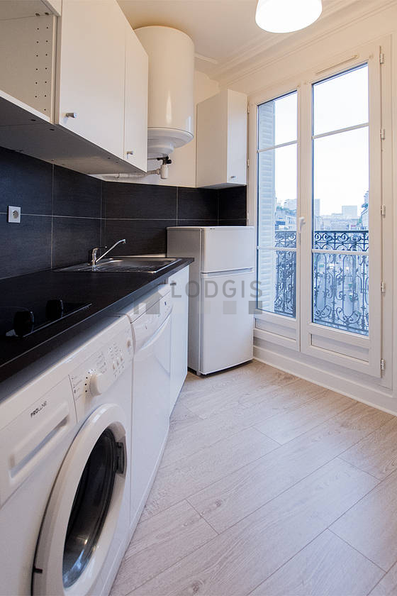 Kitchen equipped with washing machine, refrigerator, crockery