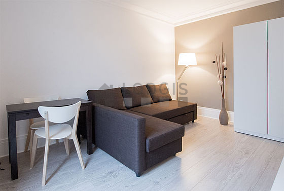 Quiet living room furnished with 1 sofabed(s) of 140cm, dining table, wardrobe, cupboard