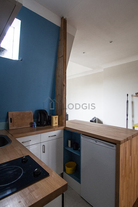Kitchen equipped with crockery, stool