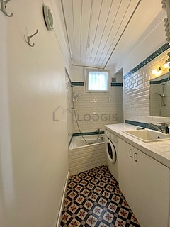Bathroom equipped with washing machine, cupboard