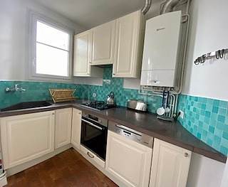 Kitchen equipped with dishwasher, hob, refrigerator, extractor hood