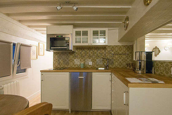 Kitchen where you can have dinner for 2 person(s) equipped with washing machine, dryer, refrigerator, extractor hood
