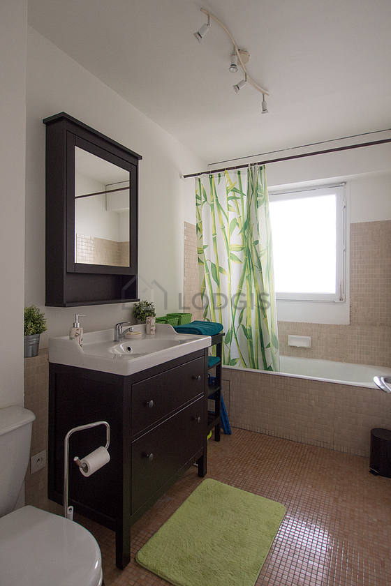 Beautiful and bright bathroom with windows and with tile floor