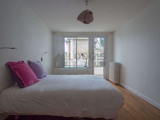 Bedroom with windows and balcony facing the garden