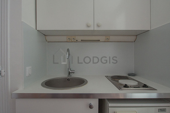 Kitchen equipped with hob, refrigerator, crockery