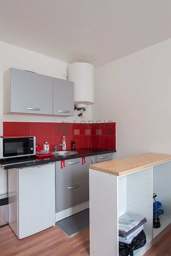 Kitchen equipped with hob, refrigerator, crockery