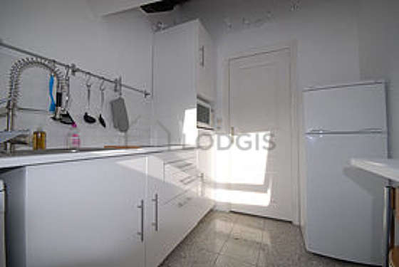 Kitchen equipped with washing machine, refrigerator, stool