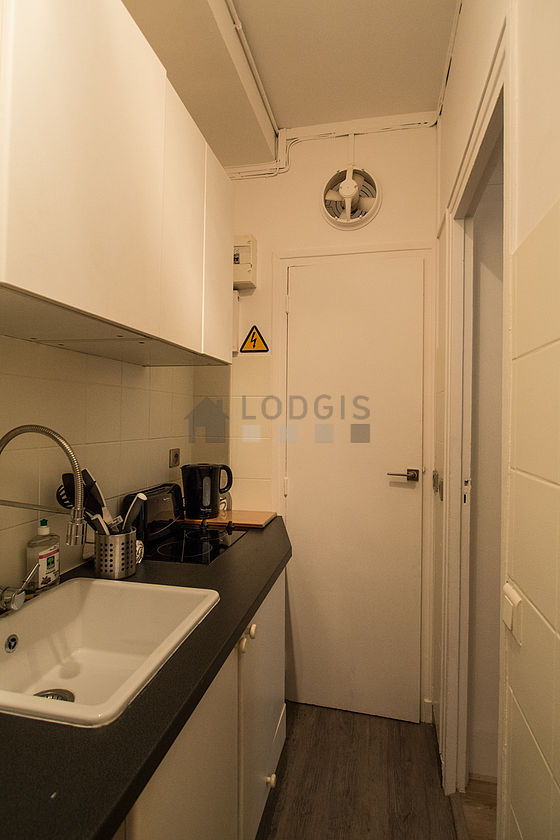 Kitchen equipped with hob, refrigerator, crockery