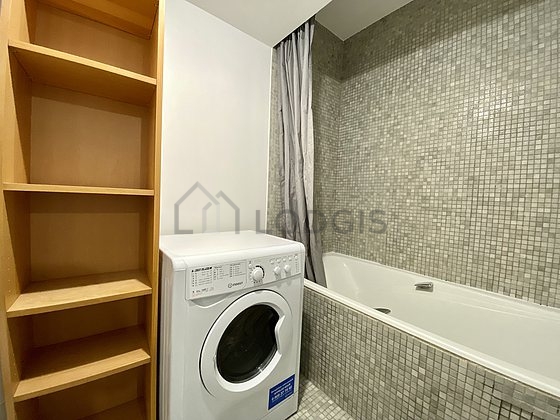 Bathroom equipped with washing machine, bath towels