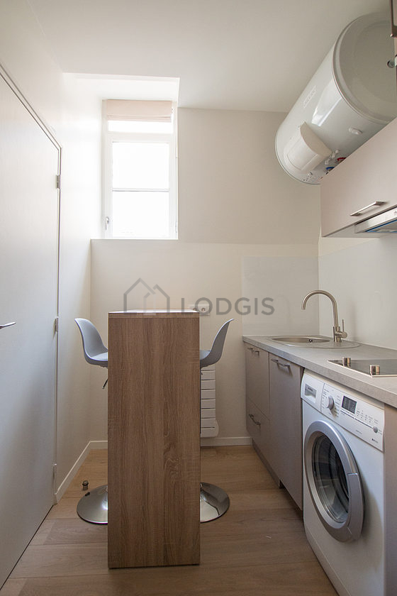 Kitchen where you can have dinner for 2 person(s) equipped with washing machine, refrigerator, extractor hood, crockery