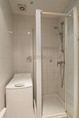 Bathroom equipped with washing machine, cupboard, electric toilet