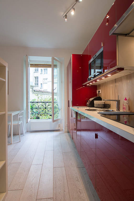 Kitchen equipped with dishwasher, hob, refrigerator, extractor hood