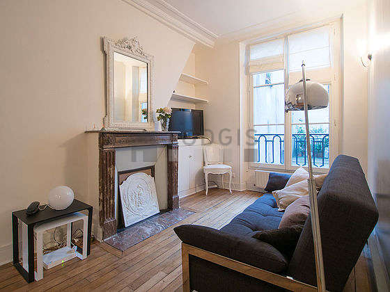 Quiet living room furnished with tv, hi-fi stereo, wardrobe, cupboard