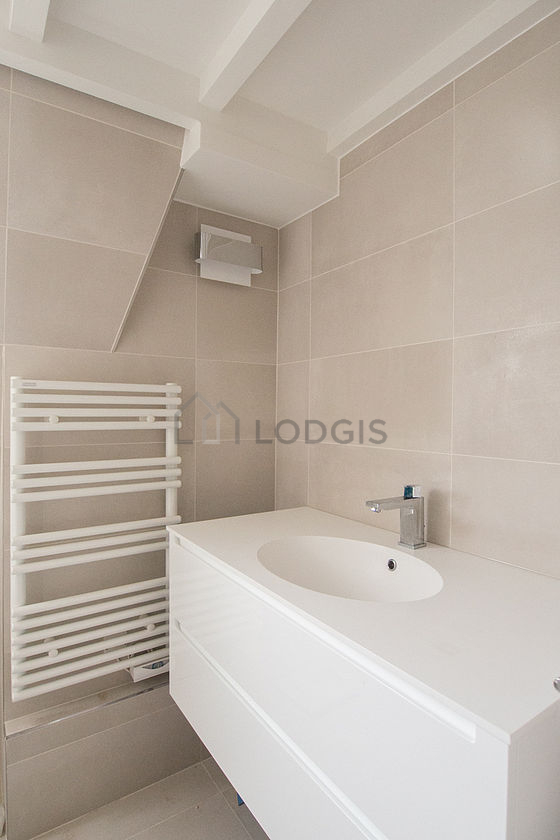 Pleasant and bright bathroom with windows and with tile floor