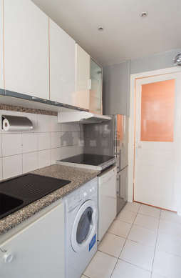 Kitchen equipped with washing machine, dryer, refrigerator, extractor hood