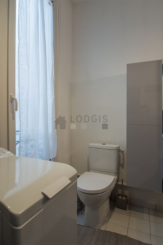 Bathroom equipped with washing machine, cupboard