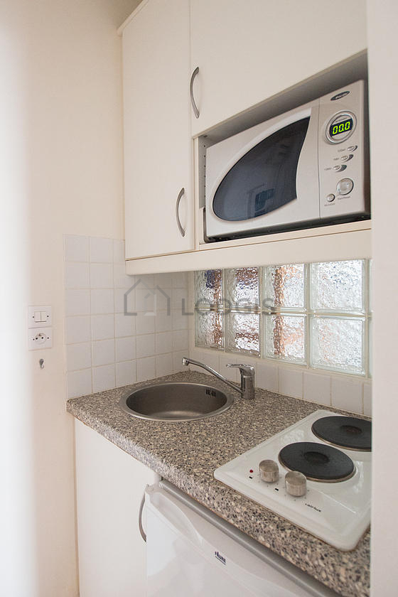 Kitchen equipped with hob, refrigerator, freezer, extractor hood