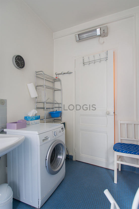 Bathroom equipped with washing machine, shelves