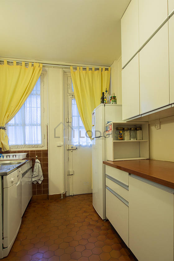 Kitchen equipped with dishwasher, hob, refrigerator, extractor hood