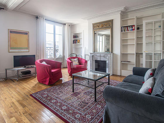 Living room with double-glazed windows and balcony facing the road