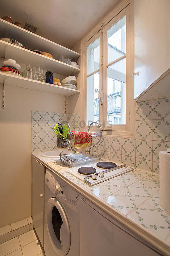 Kitchen equipped with washing machine, refrigerator, freezer, crockery